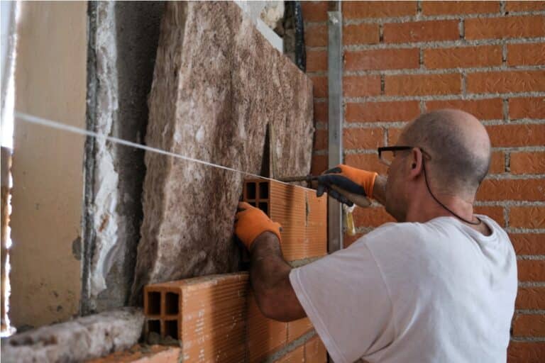 builder laying bricks after placing an acoustic an 2022 08 24 10 09 48 utc