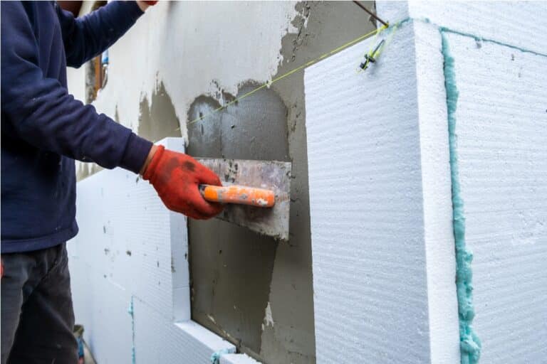construction worker installing styrofoam insulatio 2022 08 14 08 35 16 utc