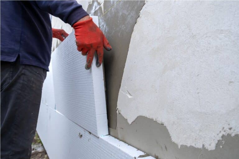 construction worker installing styrofoam insulatio 2022 12 01 05 06 49 utc