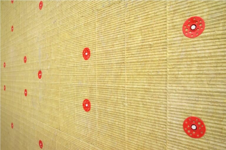 green mineral wool with dowels with red plastic caps