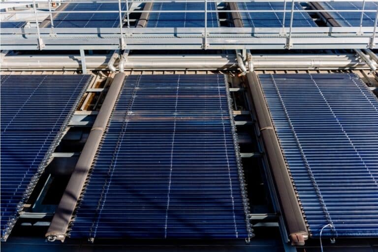 installation on a roof of large solar thermal vacuum tube plates for heating.