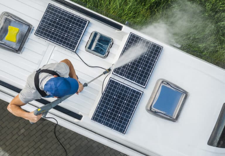 men power washing his camper van rv roof and solar panels