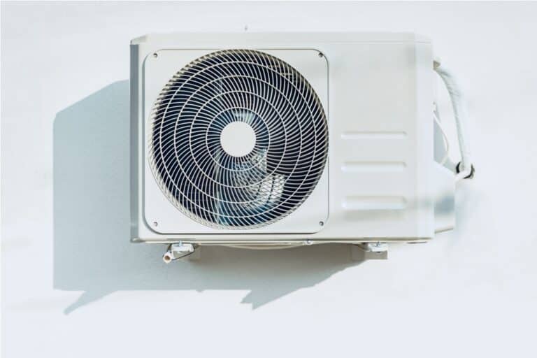 new outside air conditioner unit hanging on white wall