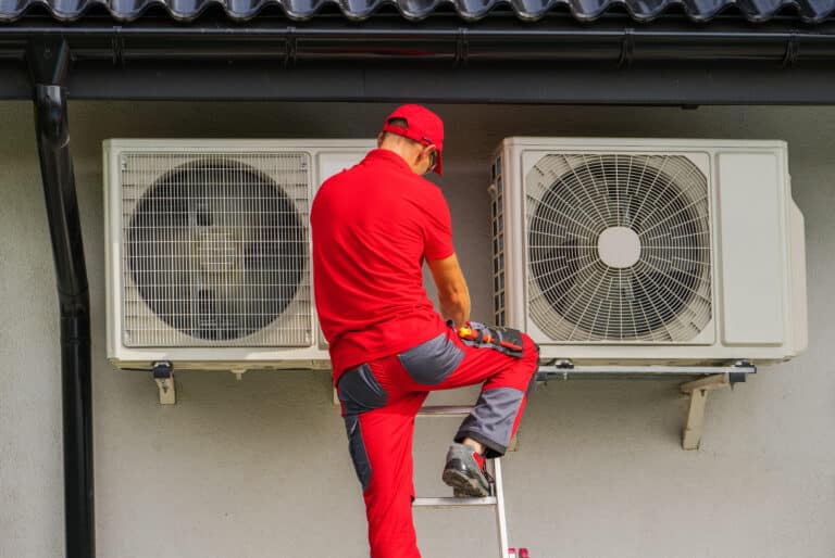 heating and cooling technician performing scheduled heat pump un